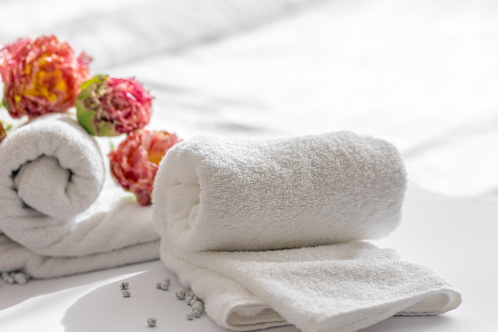 closeup-white-terry-bath-towels-and-flowers.jpg
